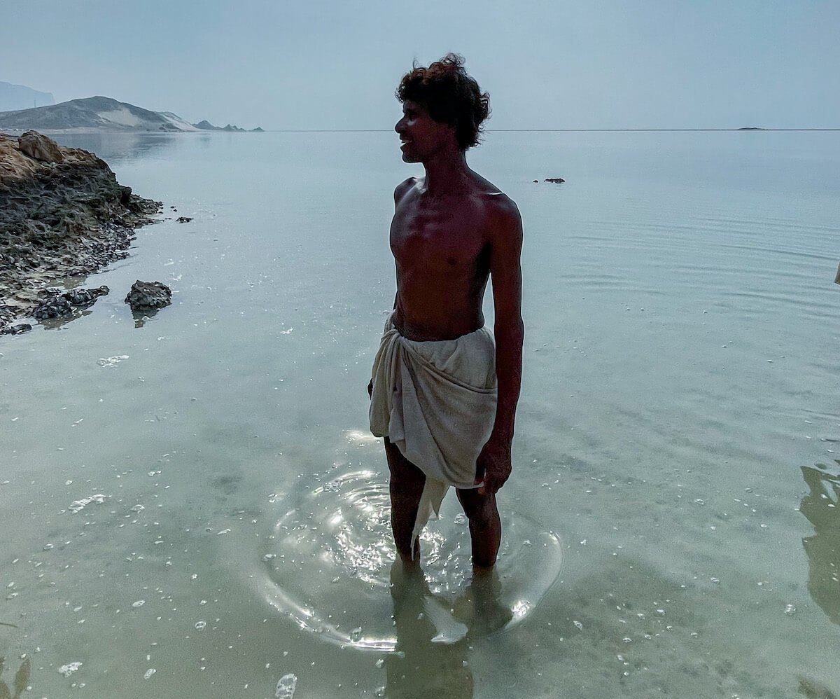 The Cave Man stands in Detwah Lagoon.