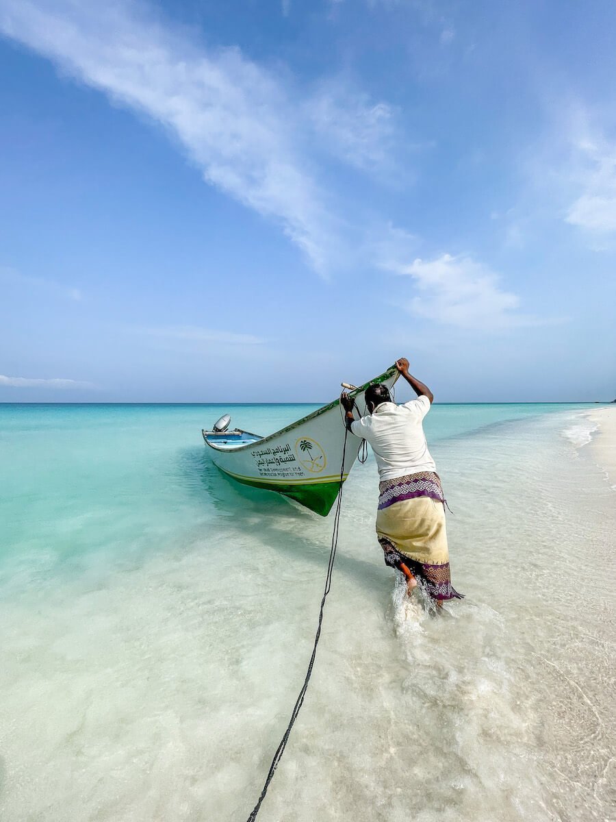 Man pushes his boat out in Socotra Shoab beach