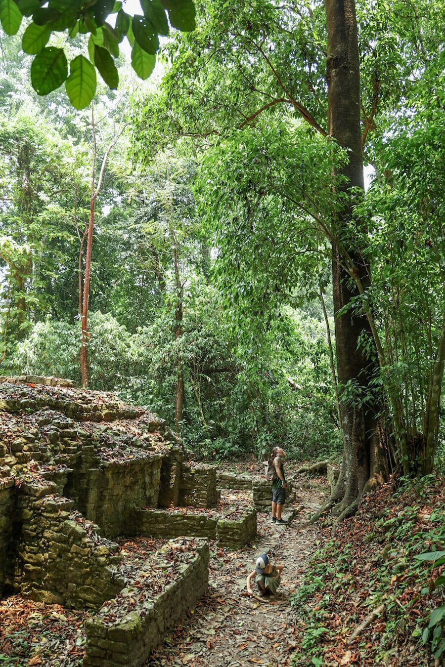 A man and girl on the outside of the Complex of Bats while on a self guided tour of Palenque.