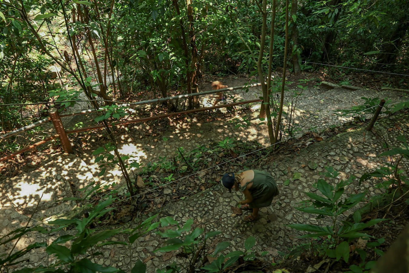 Two girls walking down the zig - zagging path at Palenques ruins