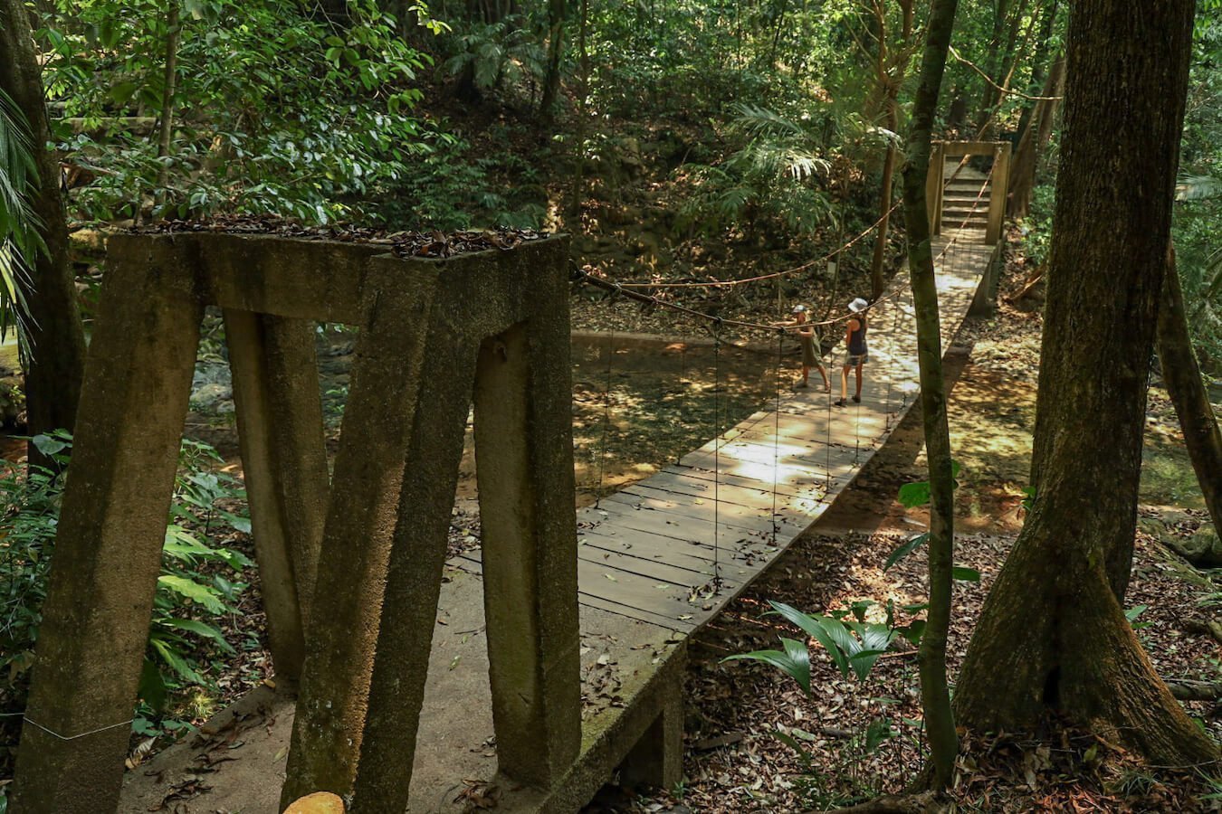 Two girls standing on the swing bridge in side Palenques archeological zone.