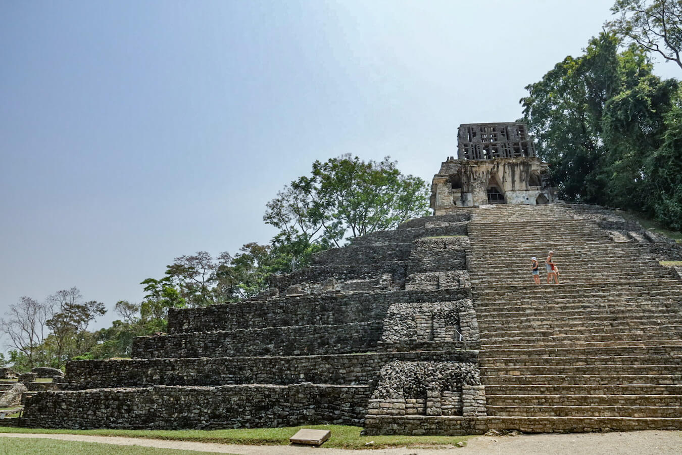 Family walking up the steeps of the Temple of the Cross, while on a self guided tour of Palenque ruins.