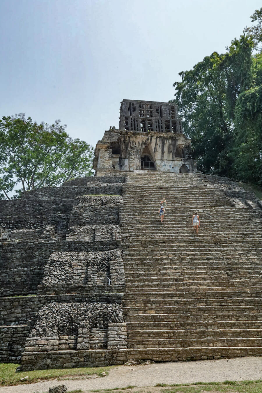 A mother and her two daughters walking up the steps of the Temple of the Cross.