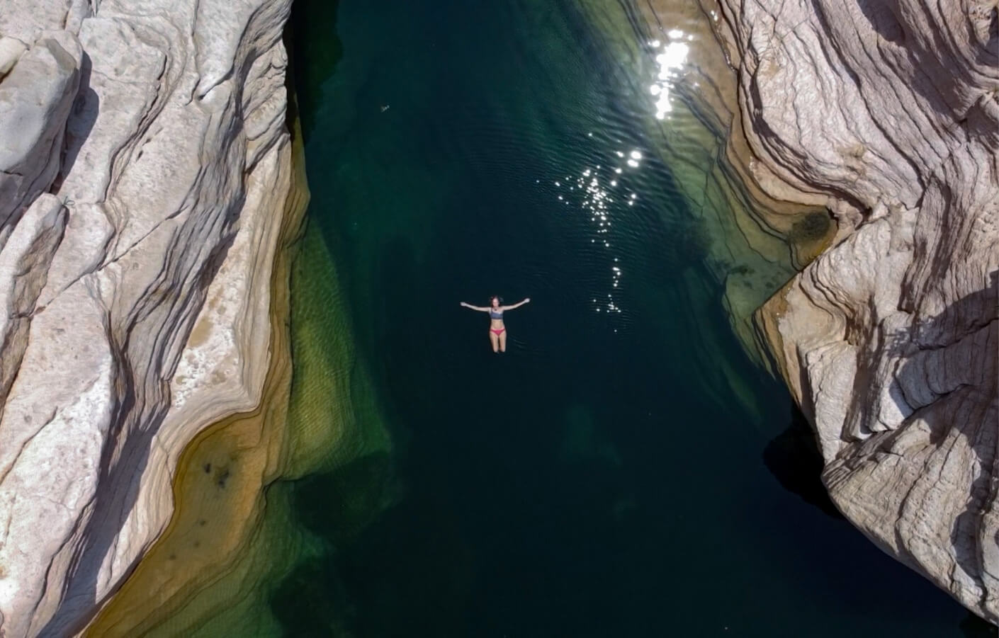 Drone photograph of woman swimming in wadi