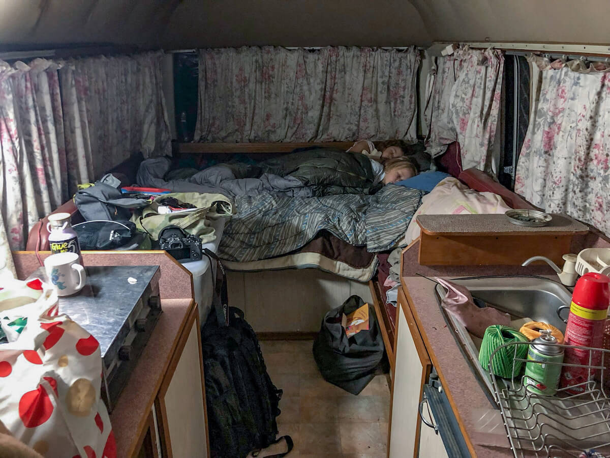 Children sleep in a bed while living on a volunteer and work exchange program in Australia
