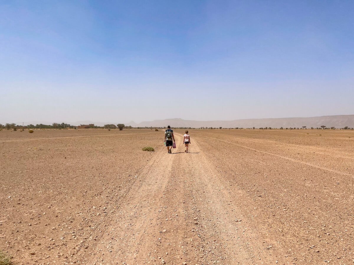Father and daughter walking home from town while on their family work exchange in Morocco.