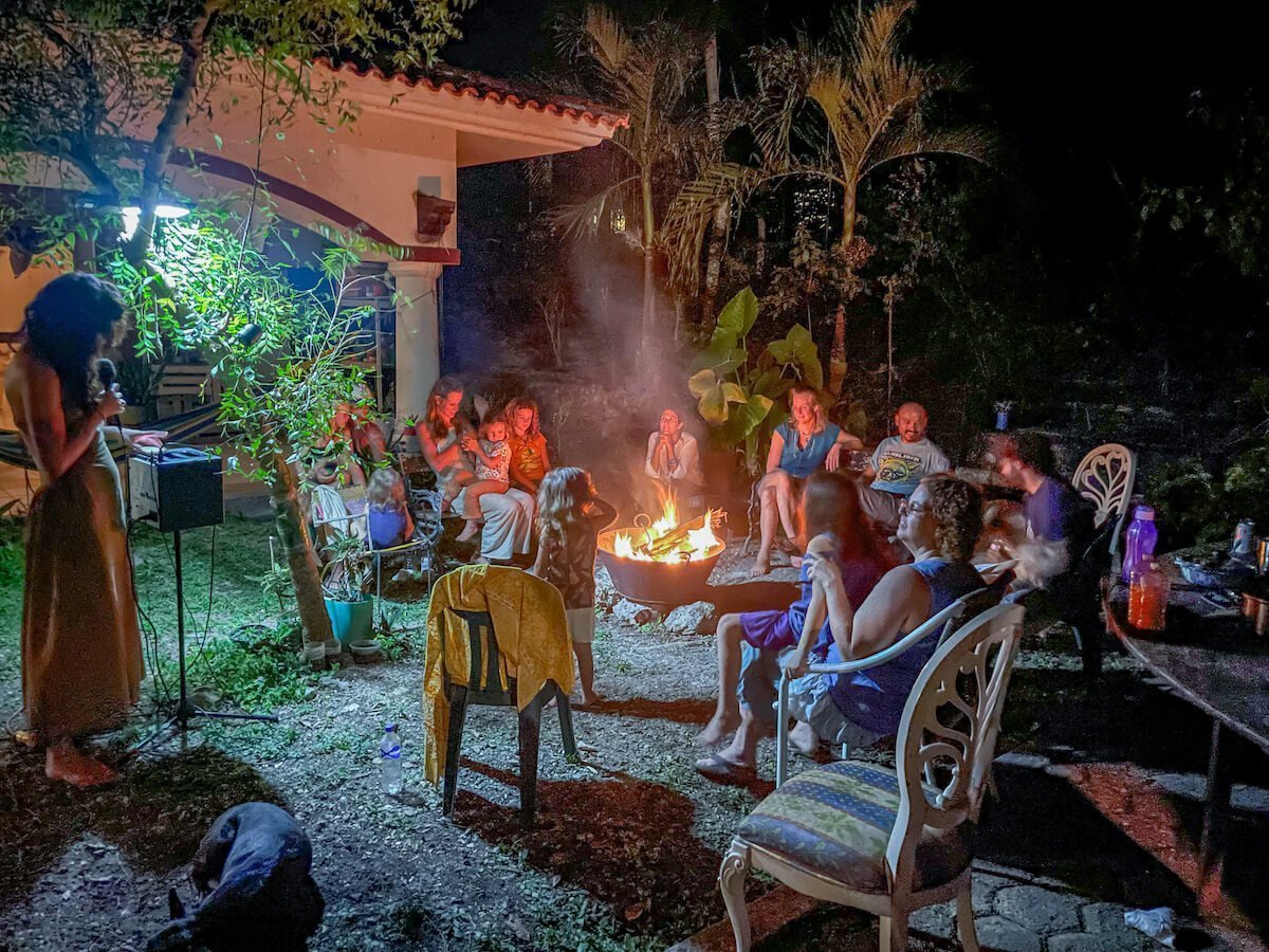A community sit around a bonfire in the evening - living on a Workaway volunteer exchange in Mexico