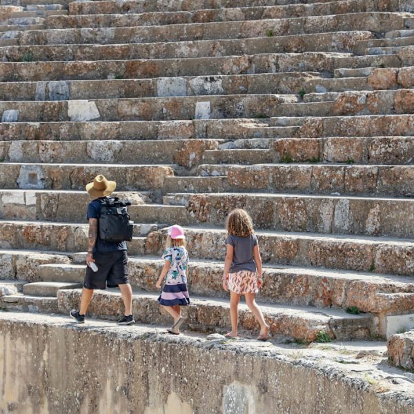 Full-time world travel family walk amphitheater through