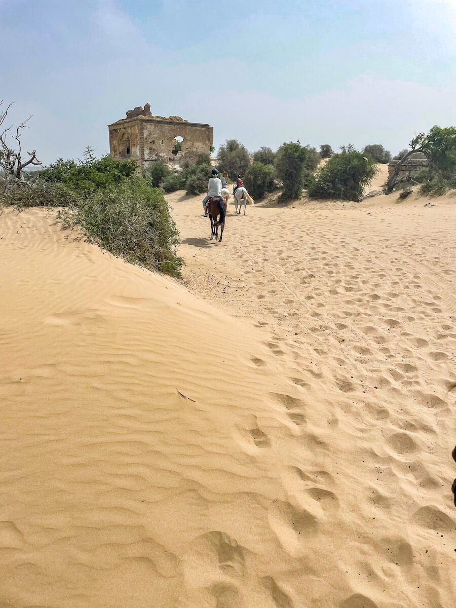A horse tour walk past the Dar Sultan Palace in Diabat, Morocco