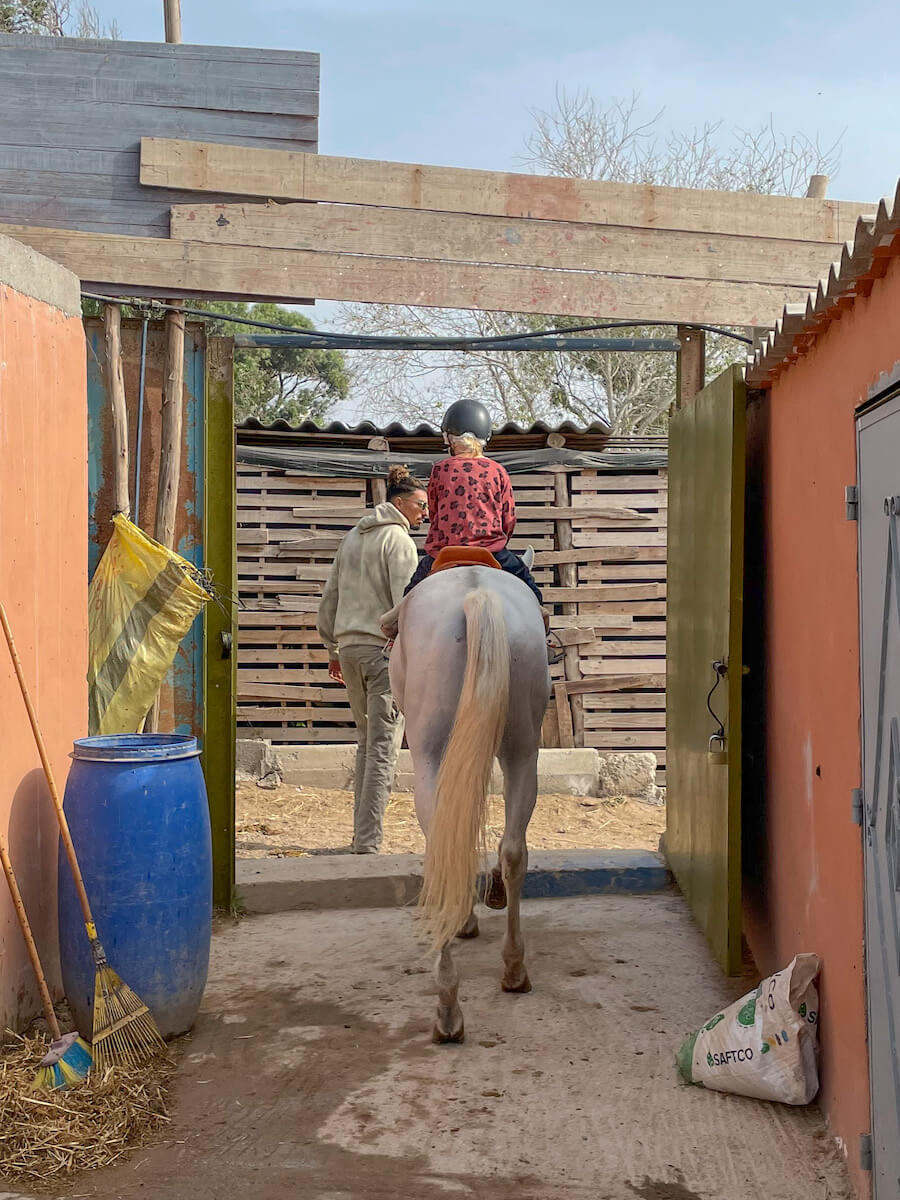 A child is led on a horse by Yassine Cavalier at his stables in Diabat