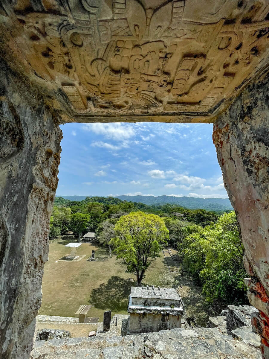 View from out of one of the structures on the acropolis at Bonampak ruins, highlighting the decorative lintel above the door opening.