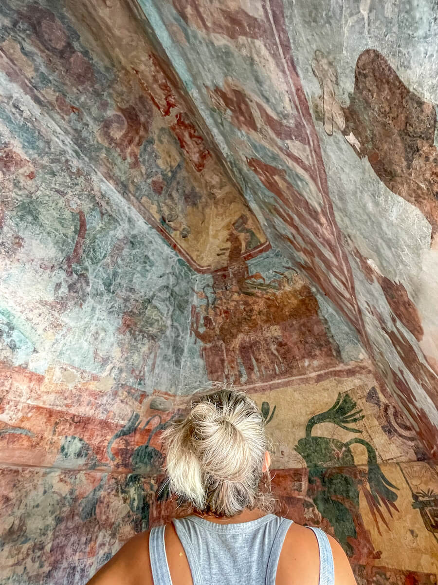 A woman admires the painted murals of the Mayan ruins at Bonampak in Chiapas