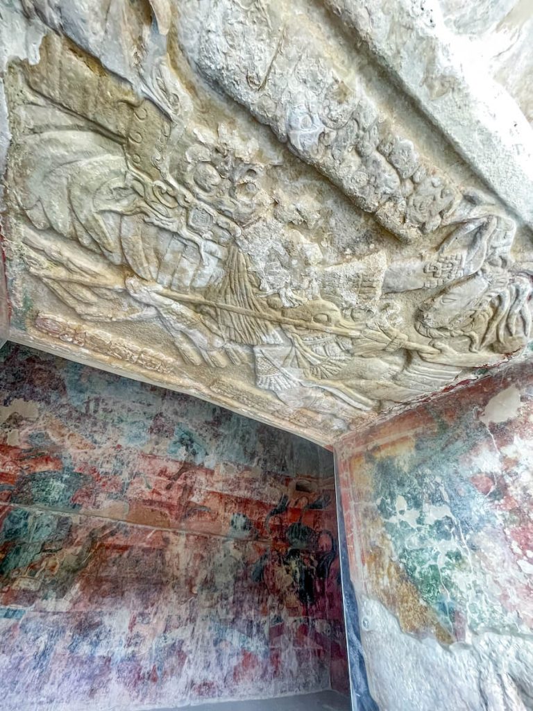 Decorative lintel, with a painted door jam and wall behind. From one of the 3 rooms in structure 1 "temple of the paintings," at Bonampak ruins.